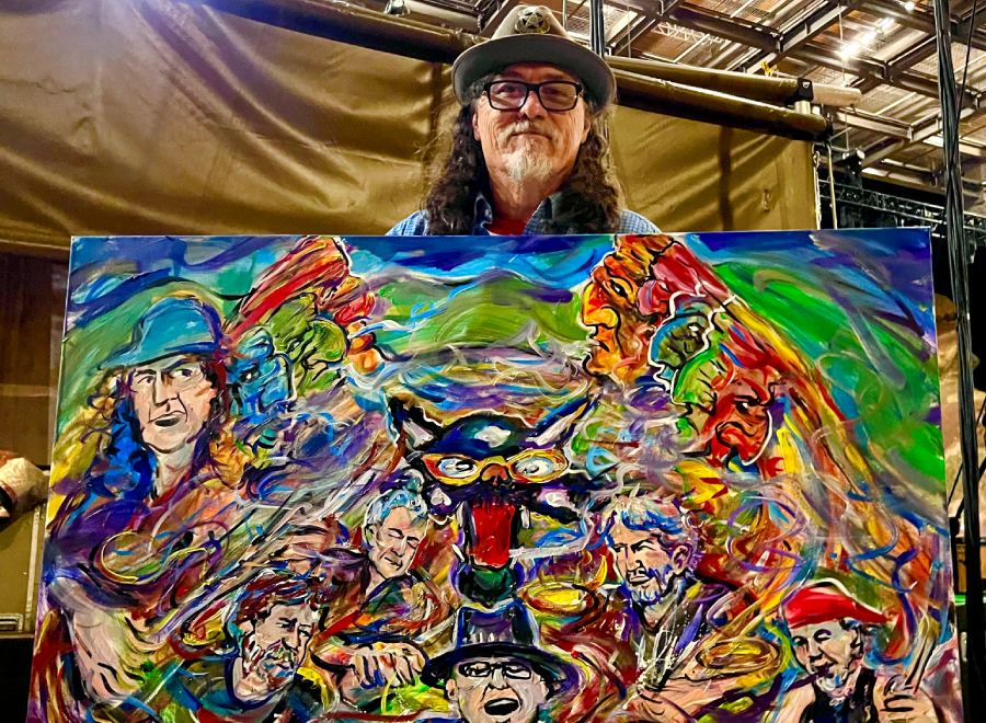 Person holding colorful abstract painting of faces