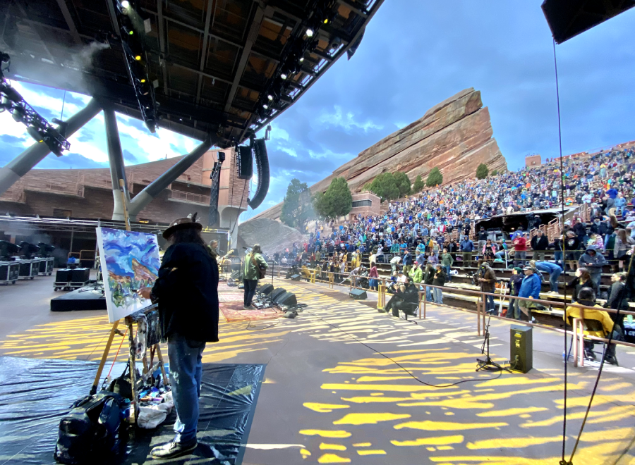 Painter onstage at packed outdoor concert venue