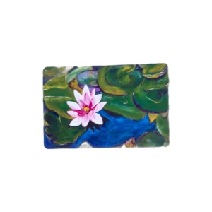 Pink water lily amid green lily pads